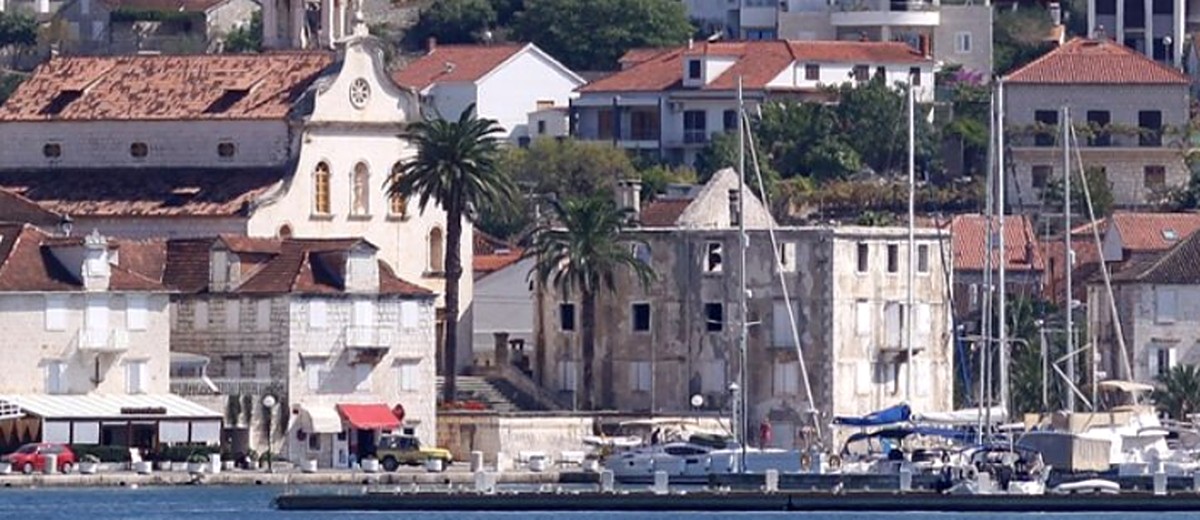 Milna harbourfront and parish church seen across the bay