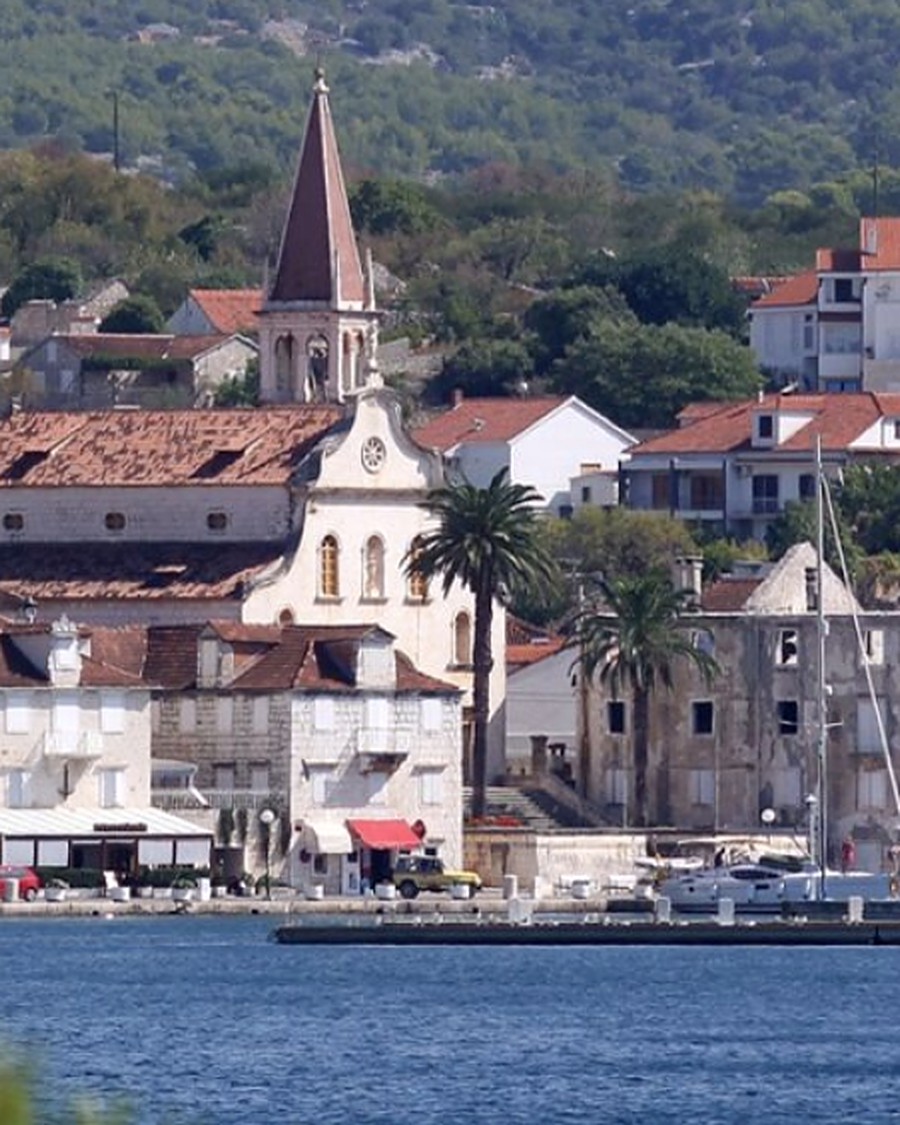 Milna harbourfront and parish church seen across the bay